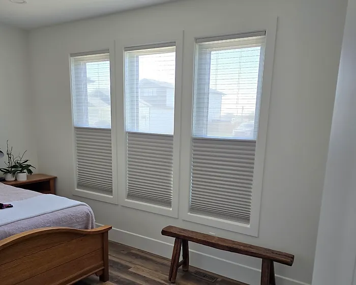 Bedroom with three windows fitted with cellular shades