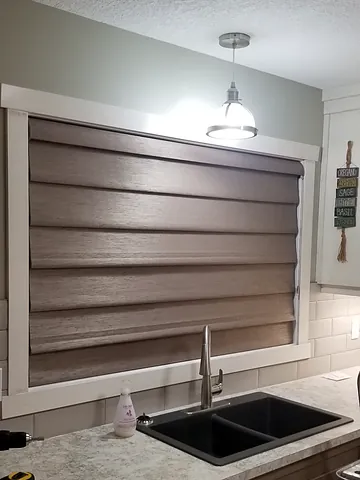 Woven shade over a kitchen sink window