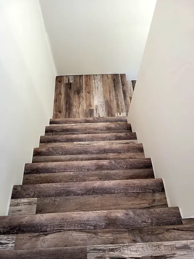 Staircase finished in weathered gray-brown plank flooring
